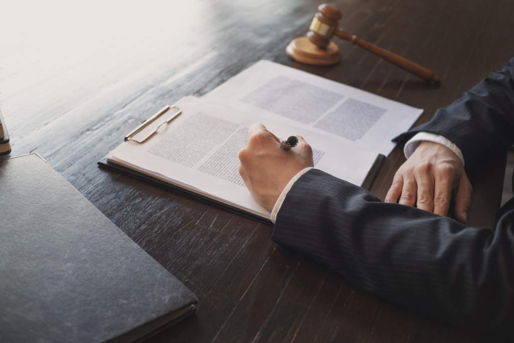 Judge taking notes during a trial.